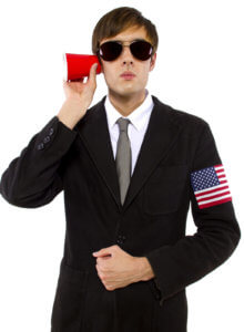 American spy wearing black suit and holding a cup